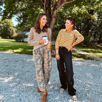 Lightweight cotton balloon pants in gray with golden florals throughout, front pleats and lace trimmed pockets. Button and zipper closure with elastic back.
