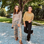 Lightweight cotton balloon pants in gray with golden florals throughout, front pleats and lace trimmed pockets. Button and zipper closure with elastic back.