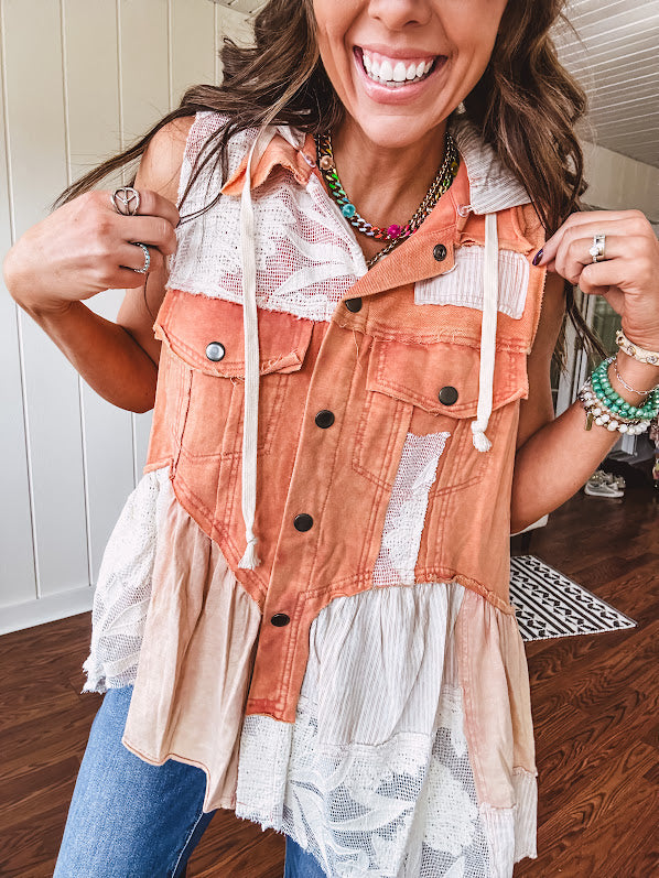 Washed terry like orange brick fabric vest with lace and mixed textured patches, a tiered, flowy bottom, snap button front, hoodie and pockets.