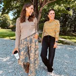 Lightweight cotton balloon pants in gray with golden florals throughout, front pleats and lace trimmed pockets. Button and zipper closure with elastic back.