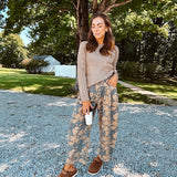 Lightweight cotton balloon pants in gray with golden florals throughout, front pleats and lace trimmed pockets. Button and zipper closure with elastic back.