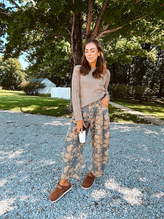 Lightweight cotton balloon pants in gray with golden florals throughout, front pleats and lace trimmed pockets. Button and zipper closure with elastic back.