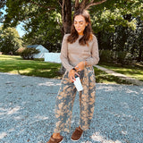 Lightweight cotton balloon pants in gray with golden florals throughout, front pleats and lace trimmed pockets. Button and zipper closure with elastic back.