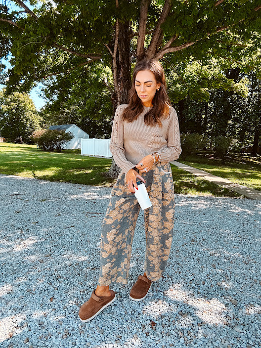Lightweight cotton balloon pants in gray with golden florals throughout, front pleats and lace trimmed pockets. Button and zipper closure with elastic back.