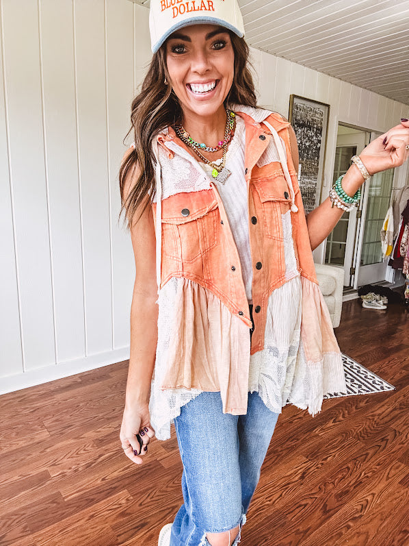 Washed terry like orange brick fabric vest with lace and mixed textured patches, a tiered, flowy bottom, snap button front, hoodie and pockets.