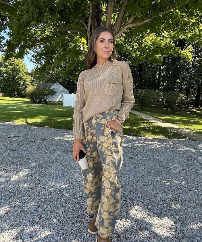 Lightweight cotton balloon pants in gray with golden florals throughout, front pleats and lace trimmed pockets. Button and zipper closure with elastic back.