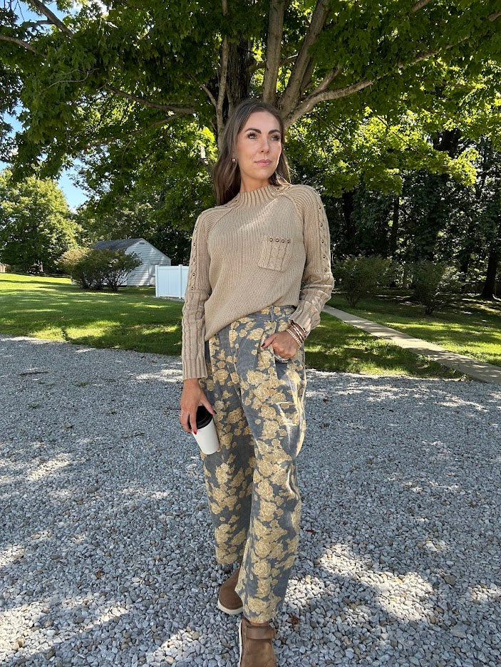 Lightweight cotton balloon pants in gray with golden florals throughout, front pleats and lace trimmed pockets. Button and zipper closure with elastic back.