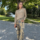 Lightweight cotton balloon pants in gray with golden florals throughout, front pleats and lace trimmed pockets. Button and zipper closure with elastic back.