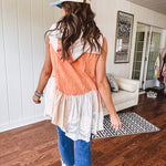 Washed terry like orange brick fabric vest with lace and mixed textured patches, a tiered, flowy bottom, snap button front, hoodie and pockets.