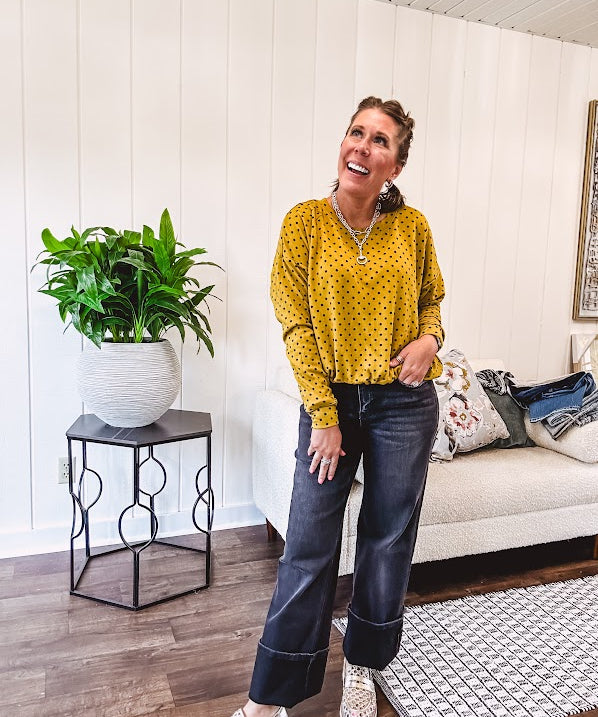 Thin, lightweight mustard long sleeved top with black polka dots throughout and elastic bubble hem.
