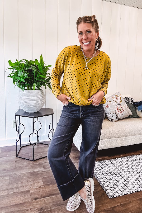 Thin, lightweight mustard long sleeved top with black polka dots throughout and elastic bubble hem.