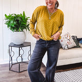 Thin, lightweight mustard long sleeved top with black polka dots throughout and elastic bubble hem.
