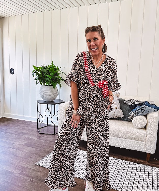 Wide leg lightweight leopard print pants with elastic waist, pockets and ruffled cuffs.