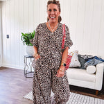 Lightweight leopard print short sleeved top with V neck and ruffled hem and cuffs.