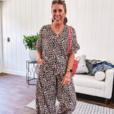 Lightweight leopard print short sleeved top with V neck and ruffled hem and cuffs.