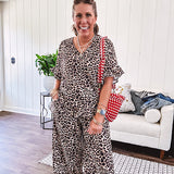 Lightweight leopard print short sleeved top with V neck and ruffled hem and cuffs.