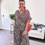 Lightweight leopard print short sleeved top with V neck and ruffled hem and cuffs.