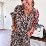 Lightweight leopard print short sleeved top with V neck and ruffled hem and cuffs.