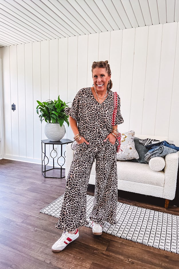 Wide leg lightweight leopard print pants with elastic waist, pockets and ruffled cuffs.