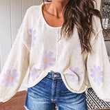 Soft, lightweight, nearly sheer knit pullover  with long sleeves, exposed seams at the shoulders and down the center with large daisy florals throughout. Available in multiple colors.