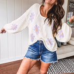 Soft, lightweight, nearly sheer knit pullover  with long sleeves, exposed seams at the shoulders and down the center with large daisy florals throughout. Available in multiple colors.