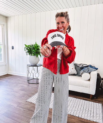 Wide leg black and white striped pants with stretch and pockets, button and zipper closure.