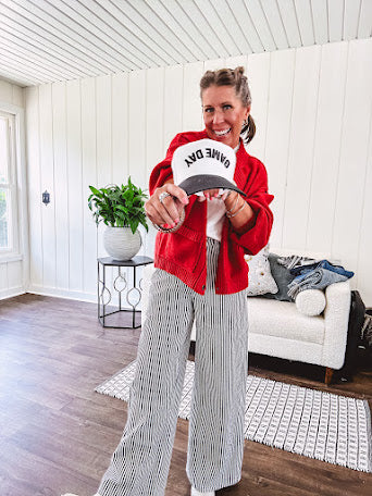 Wide leg black and white striped pants with stretch and pockets, button and zipper closure.