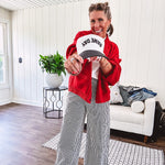 Wide leg black and white striped pants with stretch and pockets, button and zipper closure.