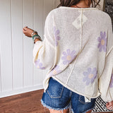 Soft, lightweight, nearly sheer knit pullover  with long sleeves, exposed seams at the shoulders and down the center with large daisy florals throughout. Available in multiple colors.