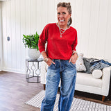Light weight red ribbed long sleeved top with white whip stitching at the round neck and cuffs.