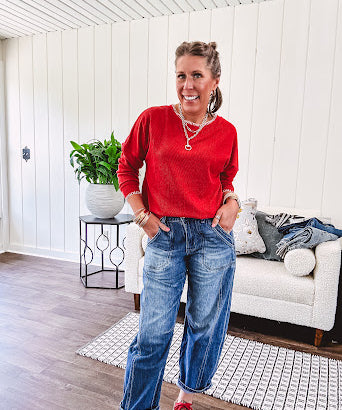 Light weight red ribbed long sleeved top with white whip stitching at the round neck and cuffs.