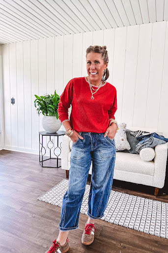 Light weight red ribbed long sleeved top with white whip stitching at the round neck and cuffs.