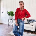 Light weight red ribbed long sleeved top with white whip stitching at the round neck and cuffs.