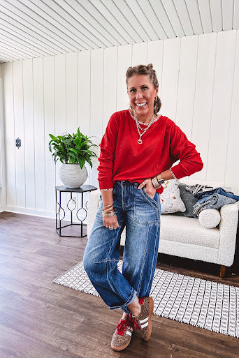 Light weight red ribbed long sleeved top with white whip stitching at the round neck and cuffs.