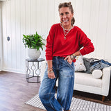 High rise medium wash barrel denim with unique side button detail on the waist and extra seam detail down the legs with large side pockets.