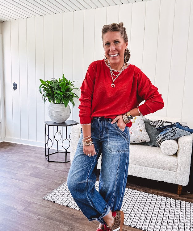 High rise medium wash barrel denim with unique side button detail on the waist and extra seam detail down the legs with large side pockets.