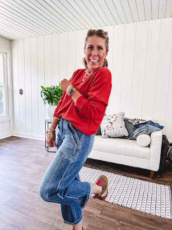 Light weight red ribbed long sleeved top with white whip stitching at the round neck and cuffs.