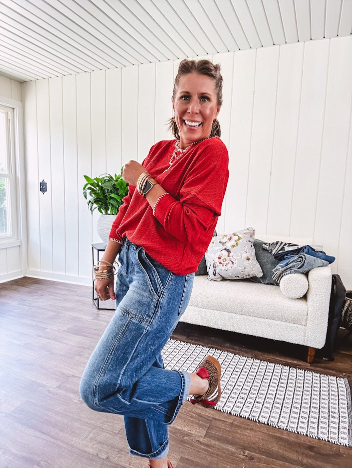 High rise medium wash barrel denim with unique side button detail on the waist and extra seam detail down the legs with large side pockets.