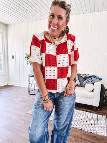 Red and white checkered crocheted short sleeved sweater with tan scalloped neckline and scalloped cuffs and hem.