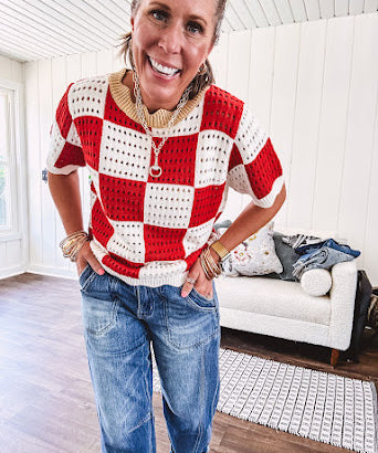 Red and white checkered crocheted short sleeved sweater with tan scalloped neckline and scalloped cuffs and hem.