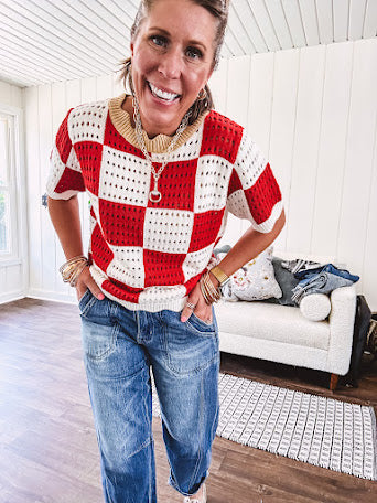 Red and white checkered crocheted short sleeved sweater with tan scalloped neckline and scalloped cuffs and hem.