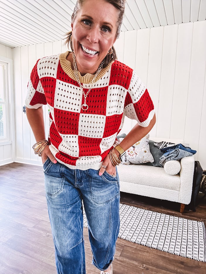 Red and white checkered crocheted short sleeved sweater with tan scalloped neckline and scalloped cuffs and hem.