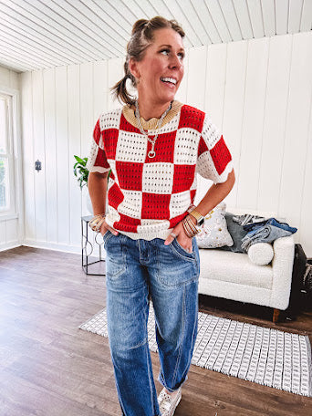 Red and white checkered crocheted short sleeved sweater with tan scalloped neckline and scalloped cuffs and hem.
