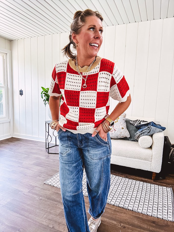 Red and white checkered crocheted short sleeved sweater with tan scalloped neckline and scalloped cuffs and hem.