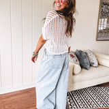Open weave short sleeved waist length sweater available in many colors.