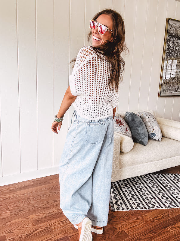 Open weave short sleeved waist length sweater available in many colors.