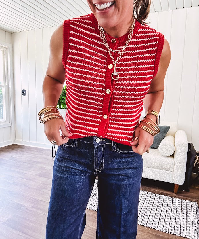 Thin red and white striped sleeveless vest with gold buttons down the front.