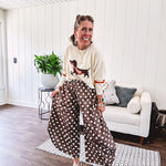 Cream lightweight long sleeved sweater with Weiner Dog graphic on front with orange stripes at the sleeves.