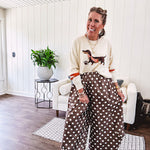 Cream lightweight long sleeved sweater with Weiner Dog graphic on front with orange stripes at the sleeves.