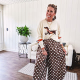 Cream lightweight long sleeved sweater with Weiner Dog graphic on front with orange stripes at the sleeves.